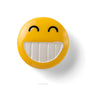 Yellow smiley face button with a happy expression on a white background