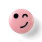 Pink ball with a smiley face design on a white background