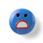 Blue round object with a face expression on a white background